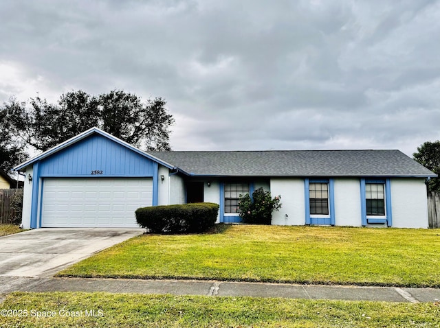 single story home with a front yard and a garage