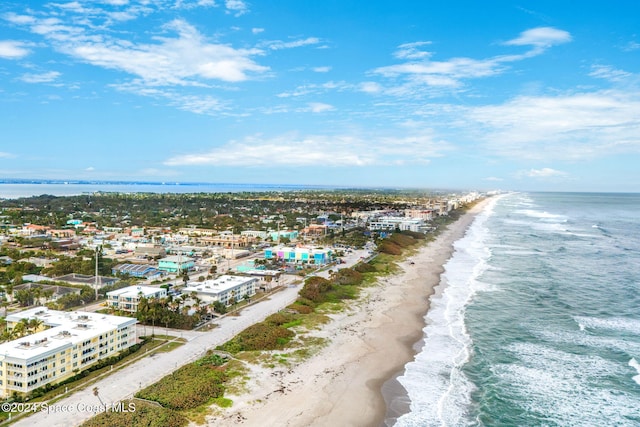 bird's eye view featuring a water view and a beach view