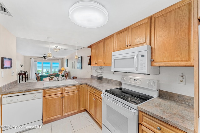 kitchen with white appliances, sink, ceiling fan, light tile patterned floors, and kitchen peninsula