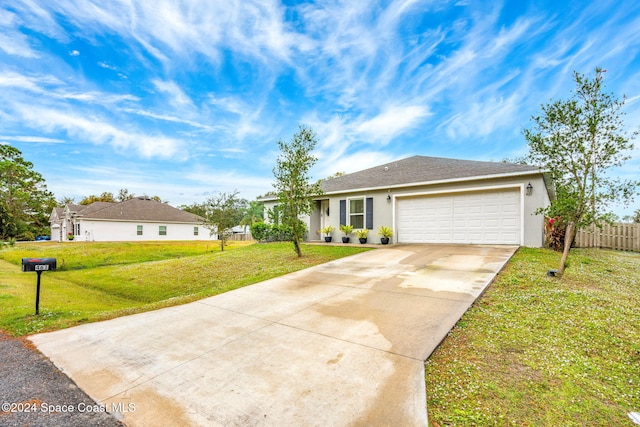 ranch-style house featuring a garage and a front lawn