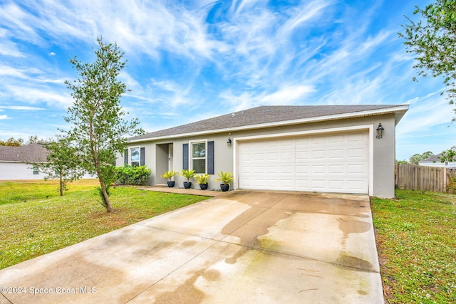 ranch-style home with a garage and a front yard