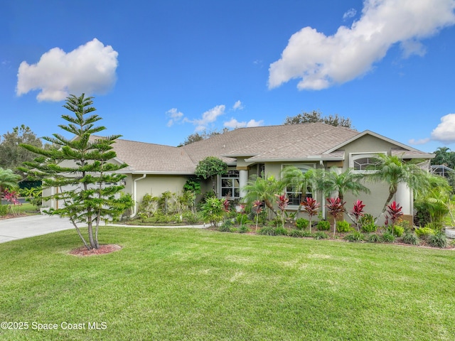 single story home with a garage and a front lawn