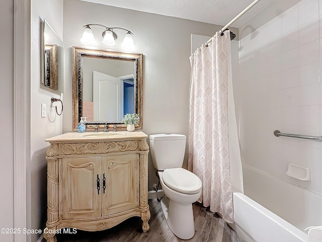 full bathroom featuring shower / tub combo, vanity, a textured ceiling, hardwood / wood-style floors, and toilet