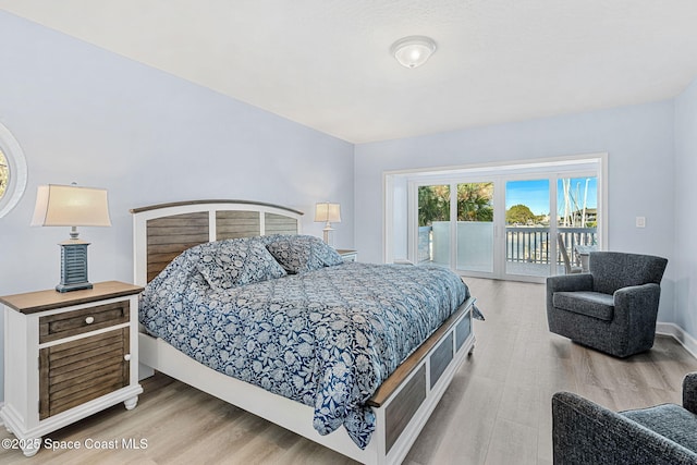 bedroom with access to outside and light hardwood / wood-style floors