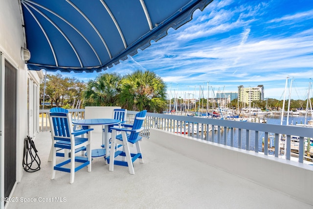 view of patio / terrace with a water view and a balcony