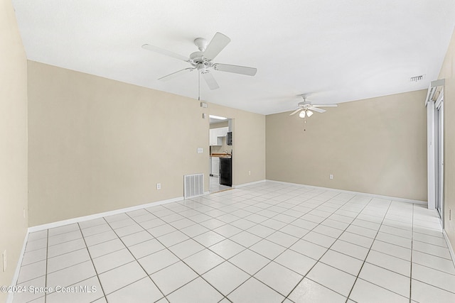 spare room featuring ceiling fan and light tile patterned flooring