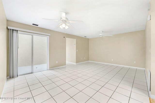 empty room featuring light tile patterned floors and ceiling fan