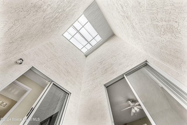 interior space with ceiling fan