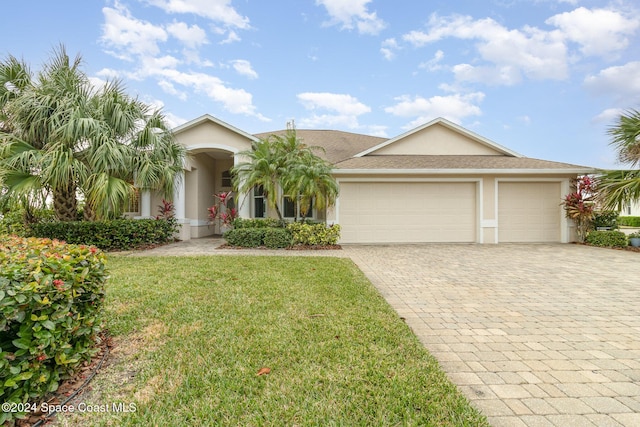 single story home featuring a front lawn and a garage