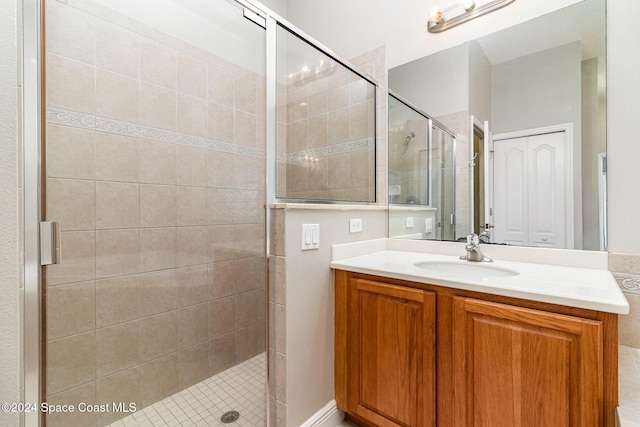 bathroom featuring vanity and a shower with shower door