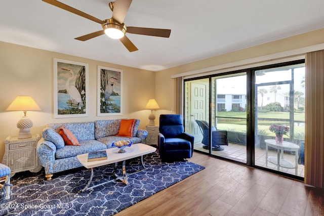 living room featuring ceiling fan and wood-type flooring