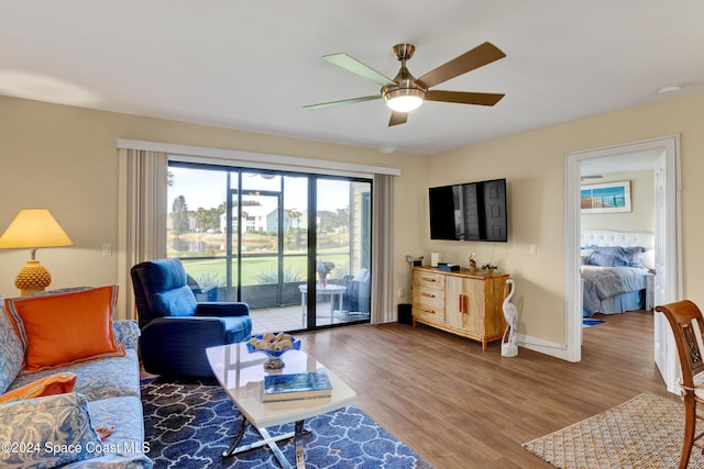 living room with ceiling fan and wood-type flooring