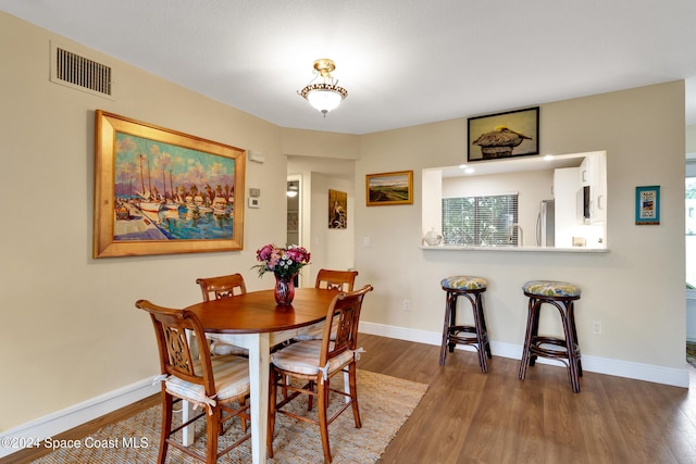 dining room with dark wood-type flooring