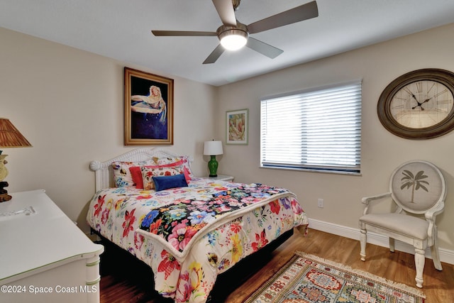 bedroom with ceiling fan and dark hardwood / wood-style flooring