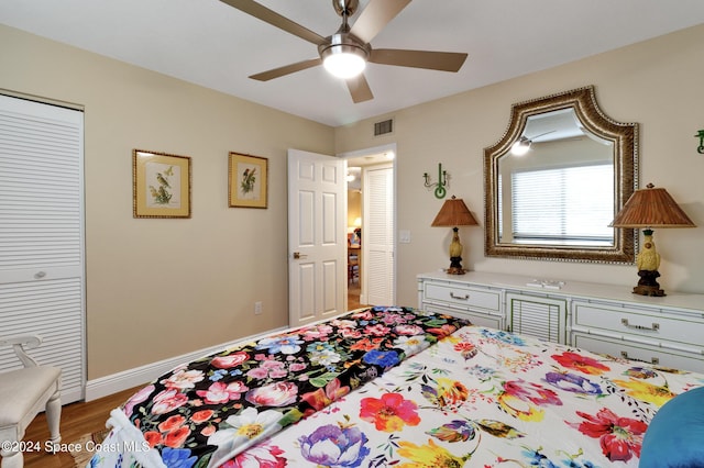 bedroom with wood-type flooring, a closet, and ceiling fan