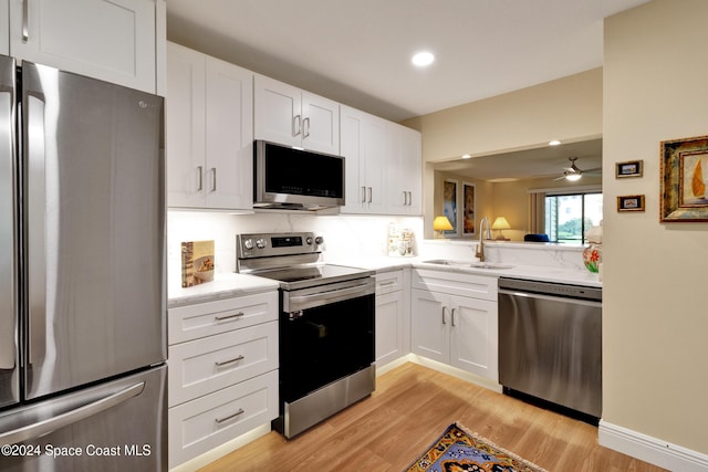 kitchen with white cabinets and appliances with stainless steel finishes