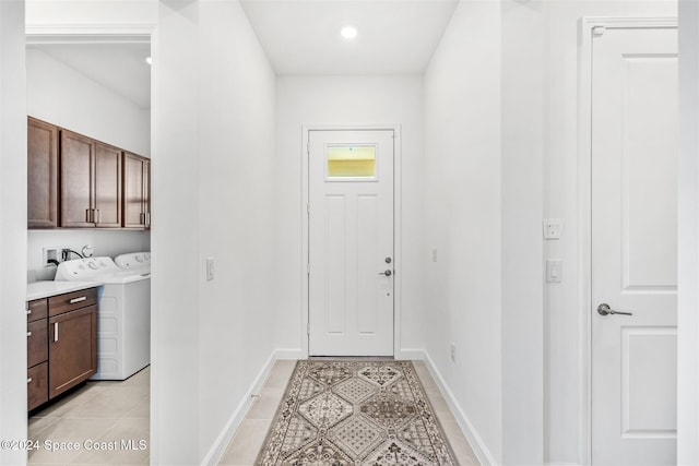 doorway with separate washer and dryer and light tile patterned flooring