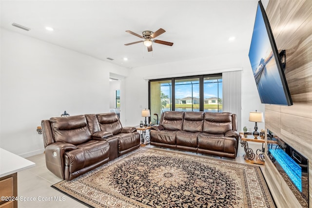 tiled living room featuring ceiling fan