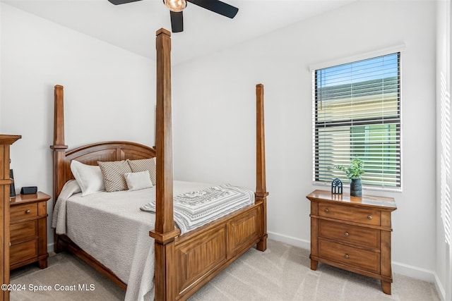 bedroom featuring light colored carpet and ceiling fan