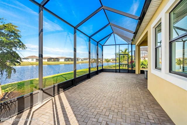 unfurnished sunroom with a water view