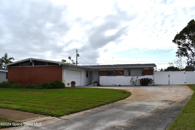 ranch-style home with a front lawn and a garage