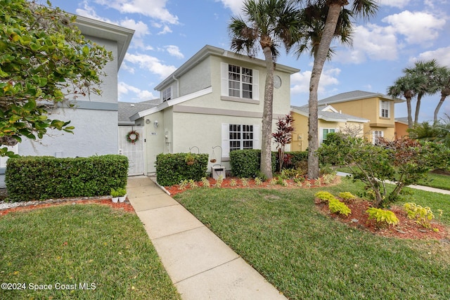 view of property featuring a front lawn