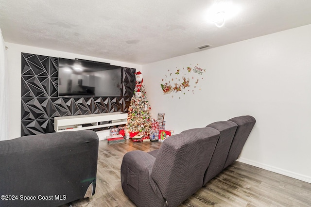 living room featuring hardwood / wood-style floors and a textured ceiling