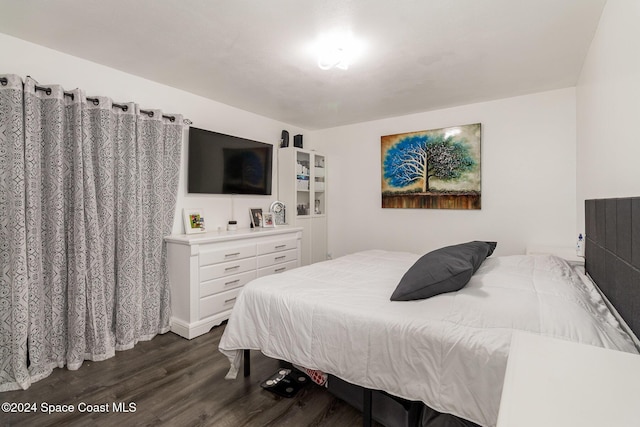 bedroom with dark wood-type flooring