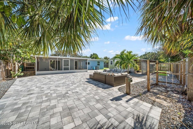 view of patio with a sunroom and an outdoor hangout area