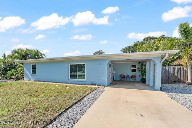 single story home with a front lawn and a carport