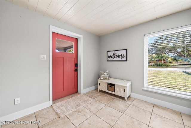 foyer with a wealth of natural light and light tile patterned flooring