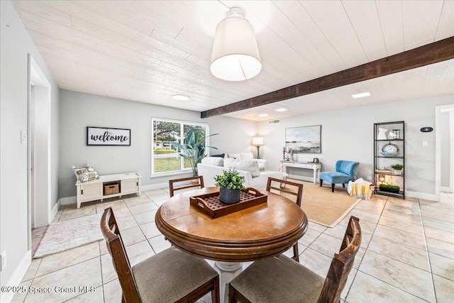 tiled dining room featuring beam ceiling and wooden ceiling