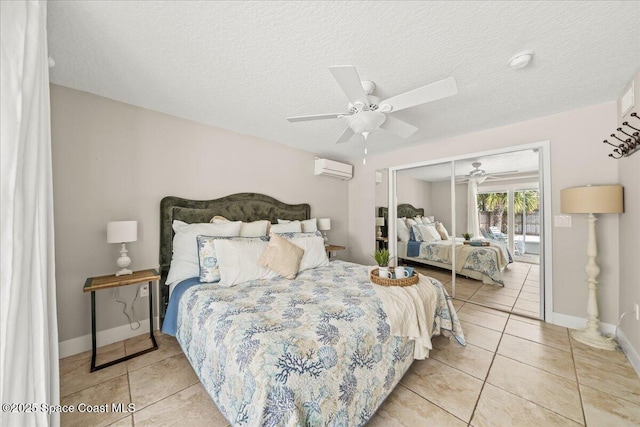 tiled bedroom with access to exterior, a textured ceiling, a wall mounted AC, ceiling fan, and a closet