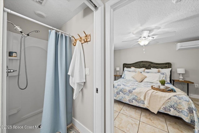 bedroom featuring ceiling fan, an AC wall unit, a textured ceiling, and light tile patterned floors