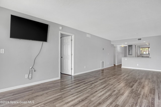 unfurnished living room with wood-type flooring