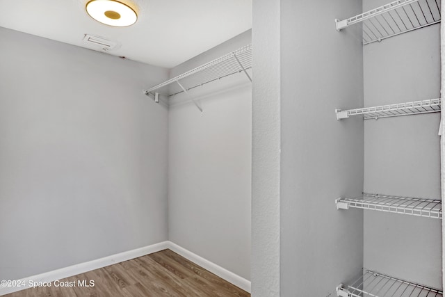 spacious closet featuring hardwood / wood-style flooring