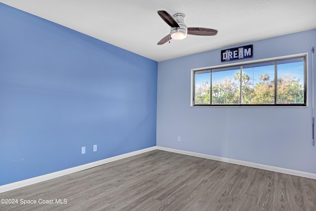 spare room with ceiling fan and hardwood / wood-style floors