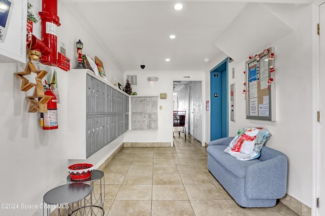 interior space featuring mail boxes, light tile patterned flooring, and ornamental molding