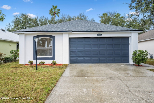 single story home with a garage and a front yard