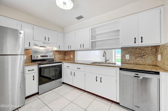 kitchen with dark stone counters, white cabinetry, sink, and stainless steel appliances