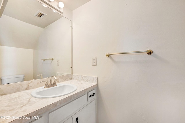 bathroom with vanity and toilet