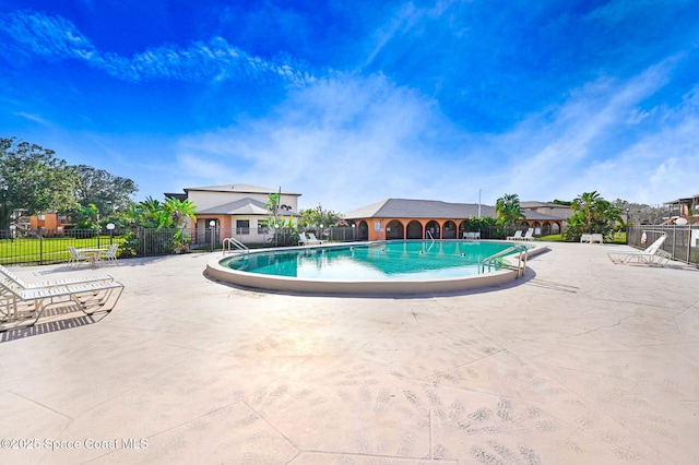 view of swimming pool with a patio area