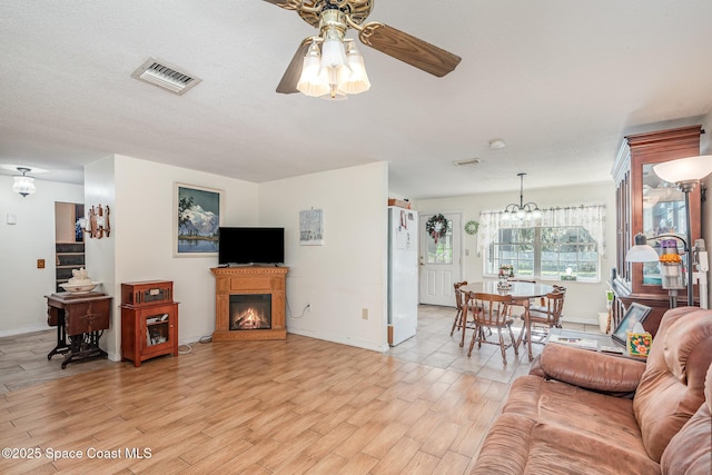 living room with ceiling fan and light hardwood / wood-style floors