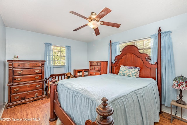 bedroom featuring light hardwood / wood-style floors and ceiling fan