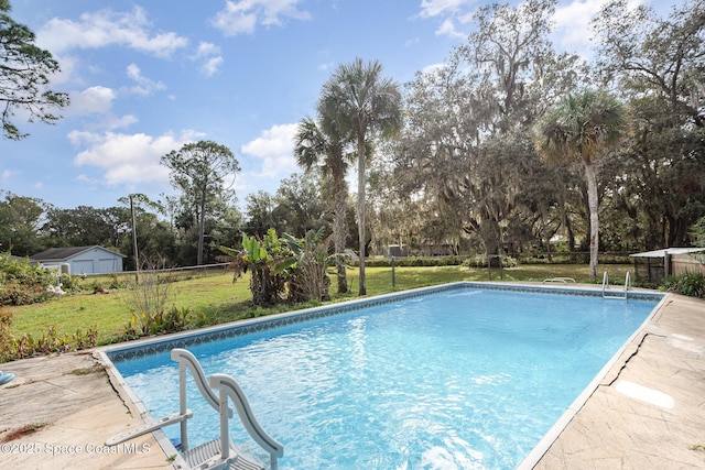 view of pool with a lawn