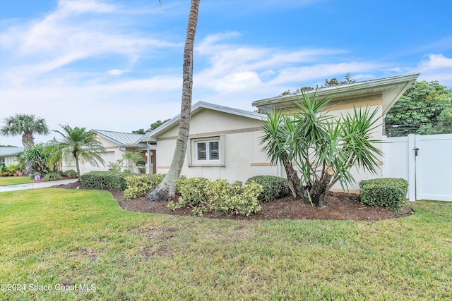 view of property exterior featuring a lawn