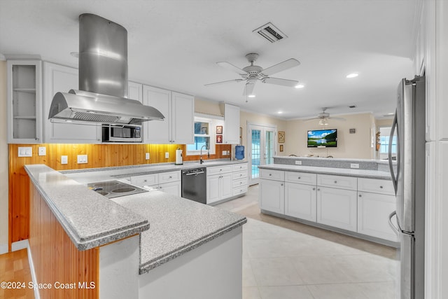 kitchen with white cabinets, ceiling fan, light tile patterned floors, island exhaust hood, and stainless steel appliances