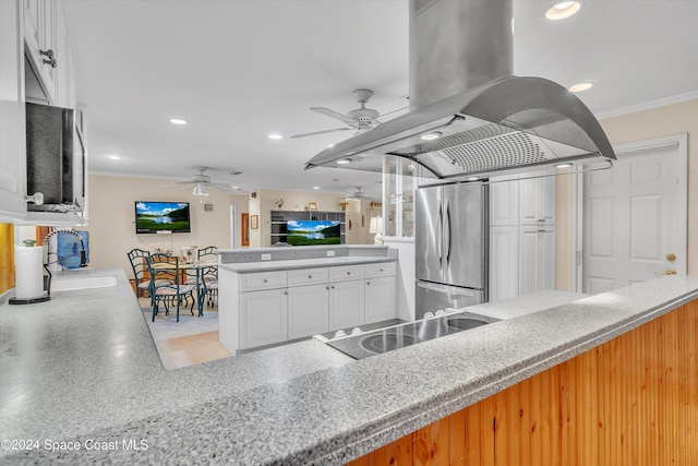 kitchen featuring stainless steel fridge, ornamental molding, white cabinetry, kitchen peninsula, and island exhaust hood