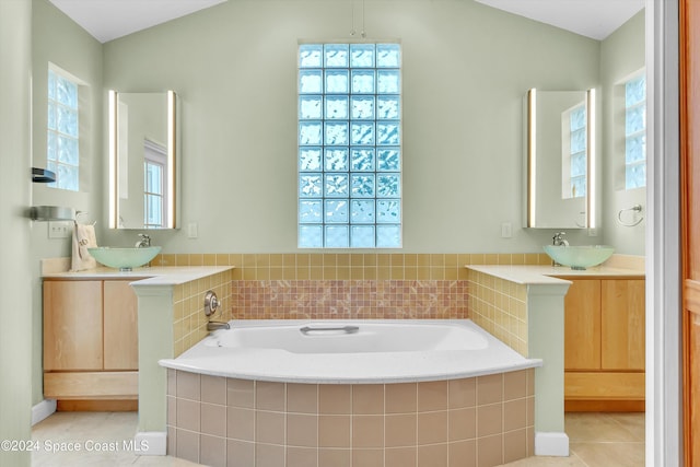 bathroom with plenty of natural light, lofted ceiling, and tile patterned flooring