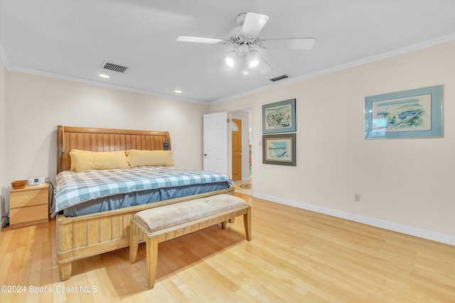 bedroom with hardwood / wood-style flooring, ceiling fan, and ornamental molding